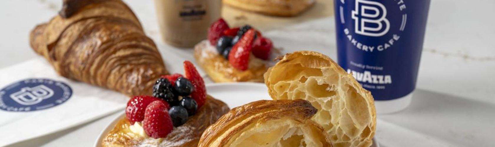 Croissants and berry-topped pastries with iced coffee at Paris Baguette cafe
