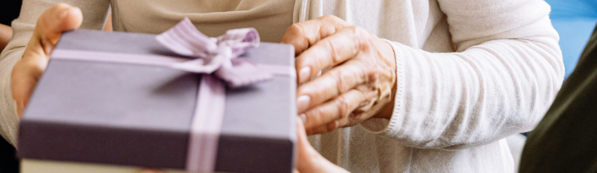 Hand holding a purple gift box